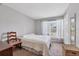 Bright bedroom with a queen-size bed and window seat at 8509 La Boca Ave, North Port, FL 34287