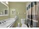 Simple bathroom with white vanity, shower, and light green walls at 8509 La Boca Ave, North Port, FL 34287