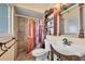 Clean bathroom with shower/tub combo, white vanity, and decorative shower curtain at 8509 La Boca Ave, North Port, FL 34287