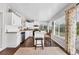 Modern kitchen with white shaker cabinets, stainless steel appliances, and an island at 8509 La Boca Ave, North Port, FL 34287