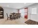 Bright dining room featuring a wood table with six chairs and access to exterior at 8509 La Boca Ave, North Port, FL 34287