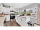 Modern kitchen with white shaker cabinets, stainless steel appliances, and an island with seating at 8509 La Boca Ave, North Port, FL 34287