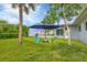 Relaxing backyard with lawn, palm tree, and seating area at 8509 La Boca Ave, North Port, FL 34287