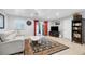 Comfortable living room with light-colored sofa, large area rug, and built-in shelving at 8509 La Boca Ave, North Port, FL 34287
