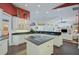 Open kitchen boasts white cabinets, granite island, and views to Gathering room at 4376 Corso Venetia Blvd, Venice, FL 34293