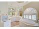 Elegant bathroom featuring a corner soaking tub and ample storage at 4376 Corso Venetia Blvd, Venice, FL 34293