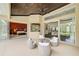 Covered patio with seating area and views to living room and pool at 4376 Corso Venetia Blvd, Venice, FL 34293