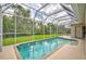 Inviting screened pool area with a large pool and lush landscaping at 4376 Corso Venetia Blvd, Venice, FL 34293