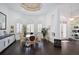 Formal dining room features hardwood floors, round table, and ample natural light at 4376 Corso Venetia Blvd, Venice, FL 34293
