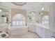Spacious bathroom with soaking tub, double vanity, and large mirror at 4376 Corso Venetia Blvd, Venice, FL 34293
