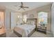 Cozy bedroom with a queen bed, en-suite bathroom access, and ceiling fan at 4376 Corso Venetia Blvd, Venice, FL 34293