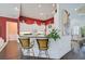 Kitchen features breakfast bar with seating and red painted walls at 4376 Corso Venetia Blvd, Venice, FL 34293