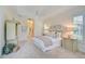 Bright and airy main bedroom with king-size bed and ensuite bath at 4376 Corso Venetia Blvd, Venice, FL 34293