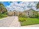 Single-Gathering home with brick paver driveway and lush landscaping at 4376 Corso Venetia Blvd, Venice, FL 34293