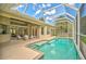 Inviting screened pool with spacious deck and lush landscaping at 4376 Corso Venetia Blvd, Venice, FL 34293
