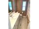 Clean and functional bathroom with a shower/tub combo and neutral tile at 21 Nautical Dr, North Port, FL 34287