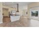 Open kitchen with island, stainless steel appliances, and white cabinets at 233 Fairway Rd, Rotonda West, FL 33947