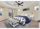 Main bedroom with plush bedding and access to the backyard at 233 Fairway Rd, Rotonda West, FL 33947