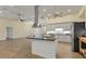 Open concept kitchen with large island, stainless steel appliances, and white shaker cabinets at 233 Fairway Rd, Rotonda West, FL 33947