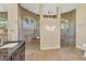 Large bathroom with walk-in shower, double vanity, and tile floors at 233 Fairway Rd, Rotonda West, FL 33947