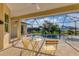 Relaxing screened-in pool area with patio furniture at 233 Fairway Rd, Rotonda West, FL 33947