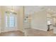 Bright and airy entryway with tile flooring, high ceilings and views into the dining and kitchen area at 233 Fairway Rd, Rotonda West, FL 33947