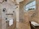 Large walk-in shower with multiple shower heads and tiled walls at 233 Fairway Rd, Rotonda West, FL 33947