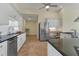 Modern kitchen with stainless steel appliances, white cabinets, and butcher block countertop at 233 Fairway Rd, Rotonda West, FL 33947