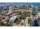 Aerial view of a modern building near the water, surrounded by other buildings and lush trees at 332 Cocoanut Ave # 503, Sarasota, FL 34236