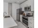 Modern kitchen with stainless steel appliances and white cabinets at 332 Cocoanut Ave # 503, Sarasota, FL 34236