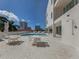 Community pool with lounge chairs and patio tables at 332 Cocoanut Ave # 503, Sarasota, FL 34236