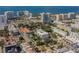 Aerial view of a modern building near the water, surrounded by other buildings and lush trees at 332 Cocoanut Ave # 503, Sarasota, FL 34236