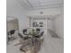Bright dining area with a glass table, zebra rug, and modern kitchen access at 332 Cocoanut Ave # 503, Sarasota, FL 34236