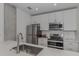 Modern kitchen with stainless steel appliances and white cabinets at 332 Cocoanut Ave # 503, Sarasota, FL 34236