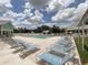 Community pool area with numerous lounge chairs at 1264 Red Oak Ln, Port Charlotte, FL 33948