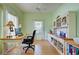 Home office with built-in shelving, hardwood floors, and a large desk at 1264 Red Oak Ln, Port Charlotte, FL 33948