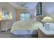 Main bedroom with en-suite bathroom, ceiling fan, and wicker furniture at 1264 Red Oak Ln, Port Charlotte, FL 33948