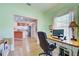 Home office with view into the kitchen and hardwood floors at 1264 Red Oak Ln, Port Charlotte, FL 33948