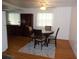 Cozy dining area with round table, four chairs, and wood-look flooring at 427 Boxwood Dr, Venice, FL 34285