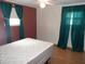 Bedroom with double bed, wood-look flooring, and teal curtains at 427 Boxwood Dr, Venice, FL 34285