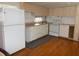 Efficient kitchen featuring white cabinets, wood flooring and appliances at 427 Boxwood Dr, Venice, FL 34285