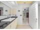 Bathroom features a vanity with black granite countertops next to the doorway to the bedroom at 4619 Flint Dr, North Port, FL 34286