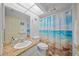 Bright bathroom featuring a decorative shower curtain, granite countertop, and ample lighting at 4619 Flint Dr, North Port, FL 34286