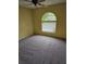 Carpeted bedroom with a ceiling fan and a large window, providing natural light at 4619 Flint Dr, North Port, FL 34286