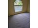 Well-lit bedroom with carpet, a large arched window, and neutral wall color at 4619 Flint Dr, North Port, FL 34286