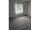 Carpeted bedroom features a large window, closet and curtain for privacy at 4619 Flint Dr, North Port, FL 34286