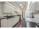 Bright kitchen with white cabinets, black countertops, and essential appliances at 4619 Flint Dr, North Port, FL 34286