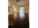 Bright living room with dark wood floors and sliding glass doors to the pool at 4619 Flint Dr, North Port, FL 34286