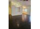 Spacious living room featuring dark wood floors, open layout, and ample natural light at 4619 Flint Dr, North Port, FL 34286