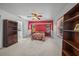 Main bedroom featuring a red accent wall, neutral carpet, and a ceiling fan at 4619 Flint Dr, North Port, FL 34286